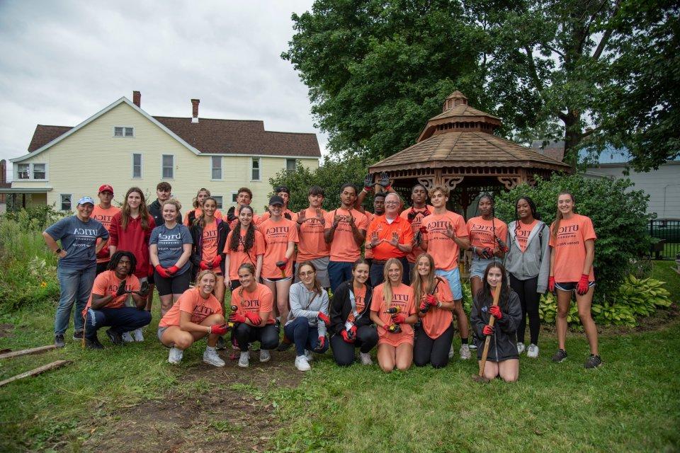 Group of students with President Pfannestiel at a Pioneer Pitch In Volunteer Site.